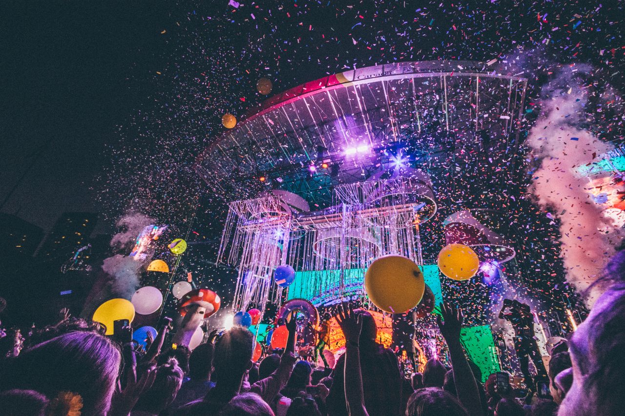 Services Exciting night concert with confetti, balloons, and a lively audience enjoying the vibrant atmosphere.